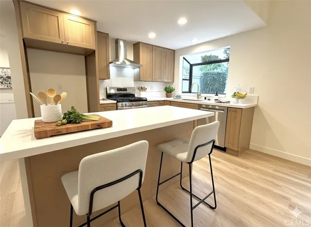 a dining room with kitchen island granite countertop furniture a large window and appliances