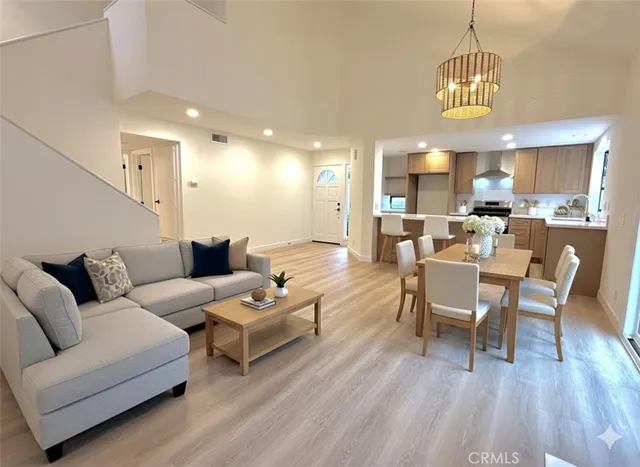 a living room with furniture dining table and a wooden floor
