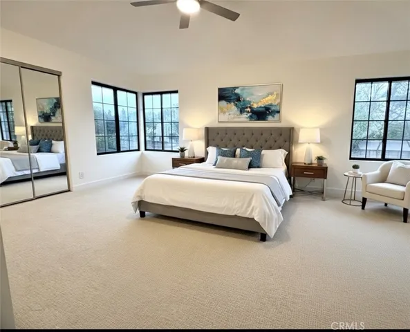 a spacious bedroom with a bed and a couch
