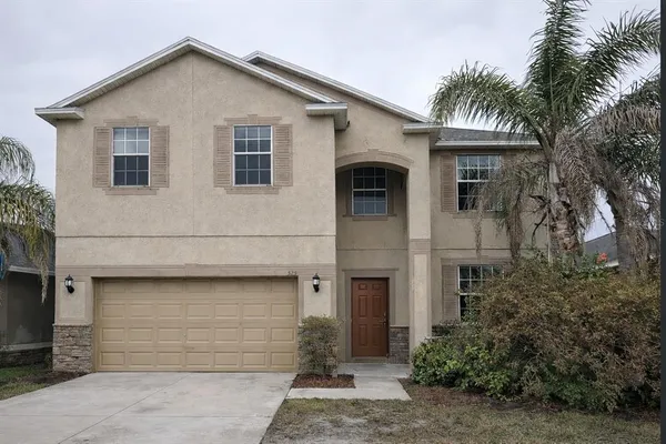 a view of house with palm trees