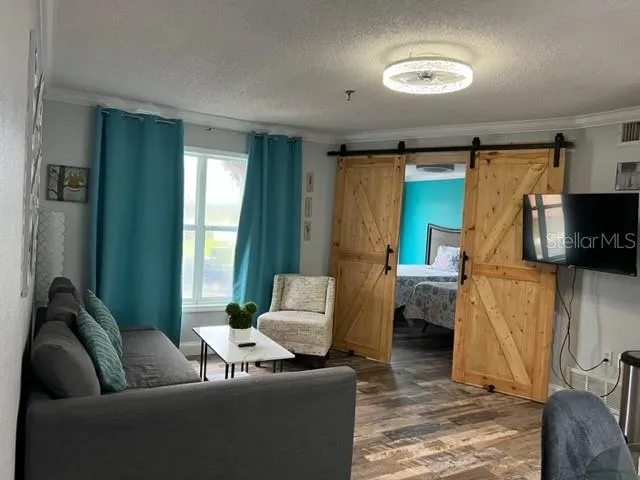 a living room with furniture and a flat screen tv