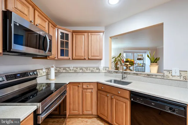 a kitchen with stainless steel appliances a sink stove and microwave
