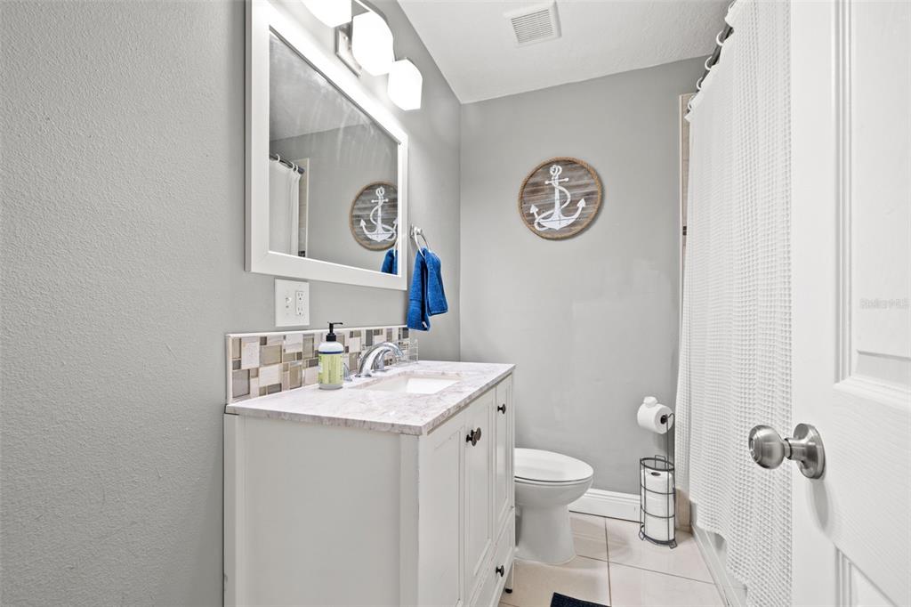 3908 Alafia Boulevard Brandon, FL 33511 - Photo 34 of 42 a bathroom with a toilet a sink and a mirror