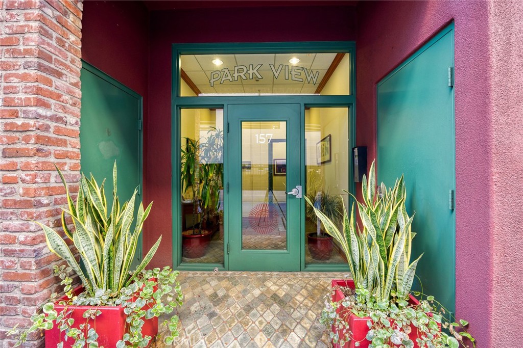 155 North Raymond Avenue Pasadena, CA 91103 - Photo 27 of 56 a front view of a house with a flower garden