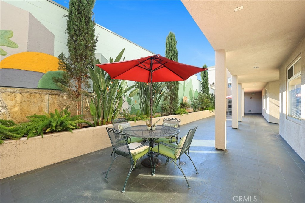 155 North Raymond Avenue Pasadena, CA 91103 - Photo 29 of 56 a view of a patio with a table and chairs under an umbrella