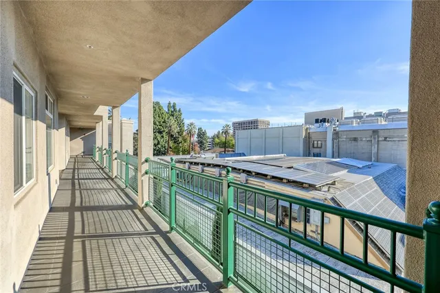 a view of a kitchen with stainless steel appliances a sink and a large window