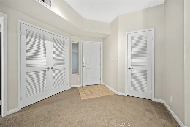 a view of a kitchen with granite countertop a sink and dishwasher with a fireplace