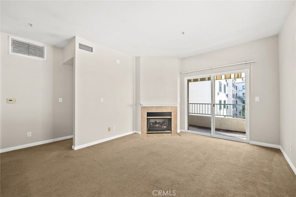 155 North Raymond Avenue Pasadena, CA 91103 - Photo 33 of 56 a view of an empty room with a fireplace and a window