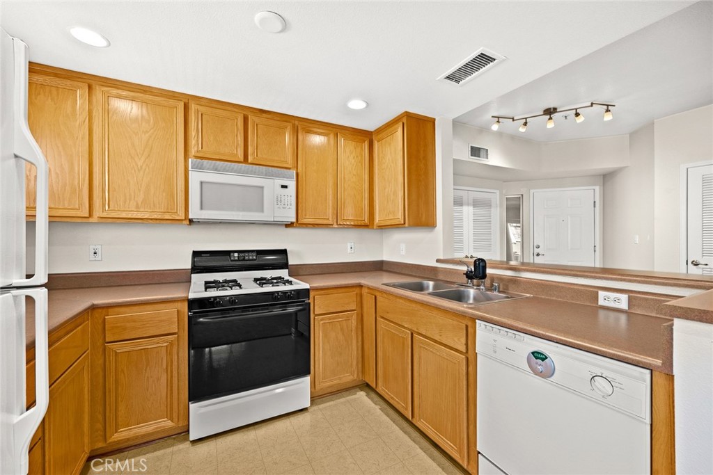 155 North Raymond Avenue Pasadena, CA 91103 - Photo 37 of 56 a kitchen with stainless steel appliances granite countertop a sink stove and cabinets