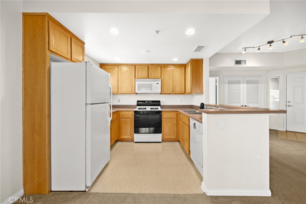155 North Raymond Avenue Pasadena, CA 91103 - Photo 39 of 56 a kitchen with granite countertop a refrigerator and a stove