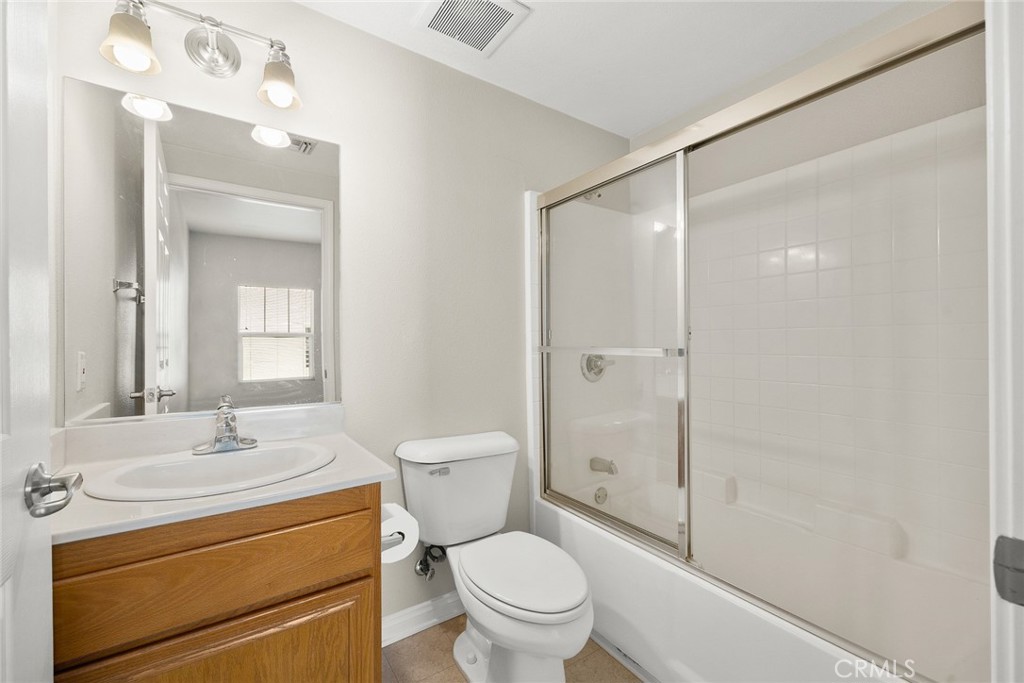 155 North Raymond Avenue Pasadena, CA 91103 - Photo 44 of 56 a bathroom with a granite countertop sink toilet a mirror and shower