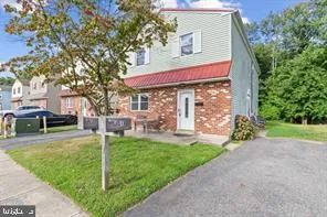 a view of a house with a yard and tree s