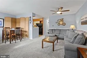 a living room with furniture and kitchen view