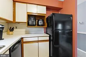 a close view of a refrigerator in kitchen and a sink