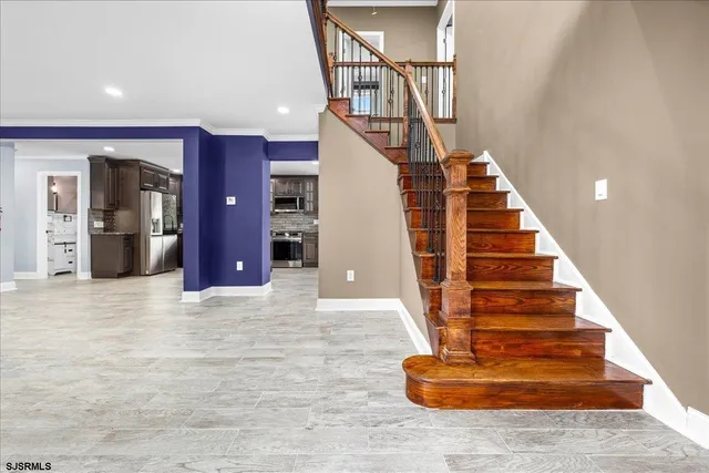 a kitchen with stainless steel appliances granite countertop a stove refrigerator sink and microwave