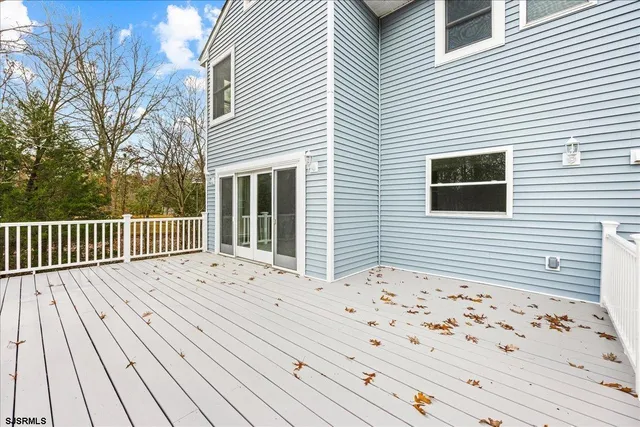 a view of a kitchen with a sink and dishwasher with wooden floor