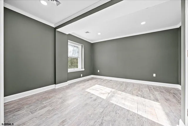 a view of hallway with a couch and chandelier