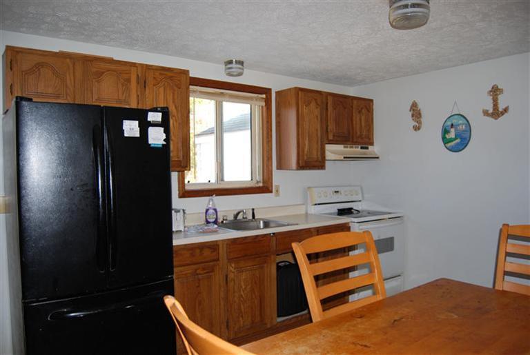 10 Red Brook Road, Unit A & B East Wareham, MA 02538 - Photo 6 of 15 a kitchen with a refrigerator and sink