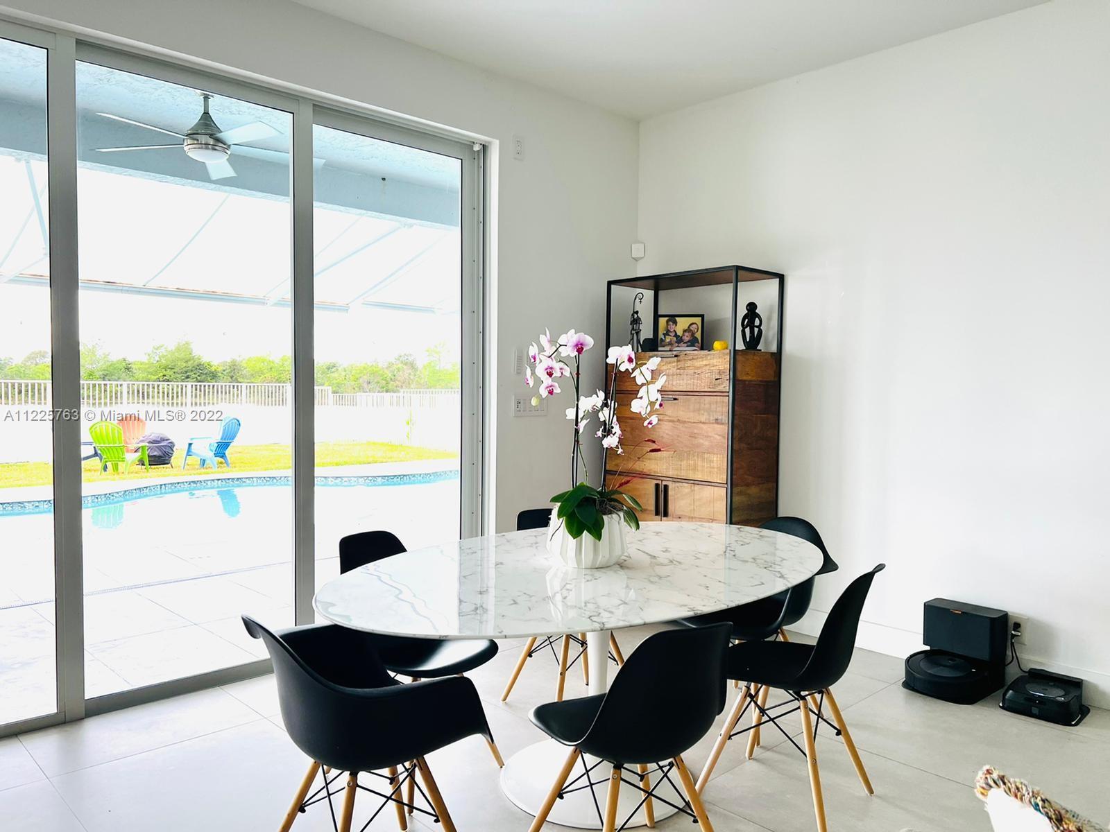 862 Tulip Circle Weston, FL 33327 - Photo 12 of 29 a view of a dining room with furniture and a window