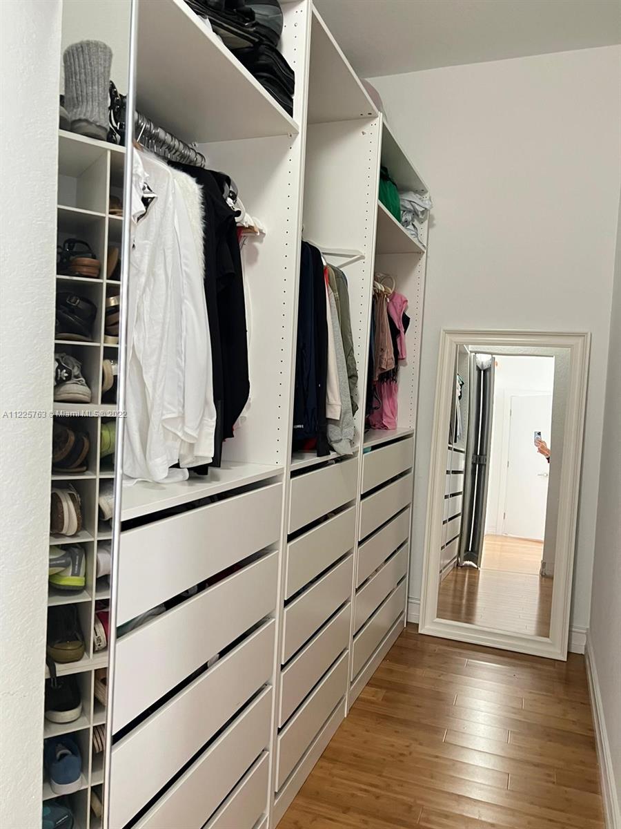 862 Tulip Circle Weston, FL 33327 - Photo 14 of 29 a view of walk in closet with clothes and shoes