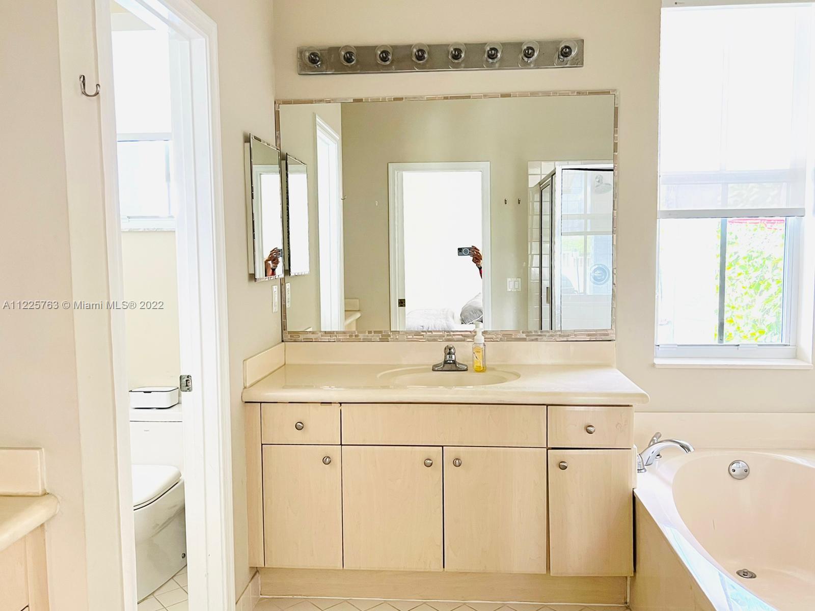 862 Tulip Circle Weston, FL 33327 - Photo 16 of 29 a bathroom with a sink and a mirror