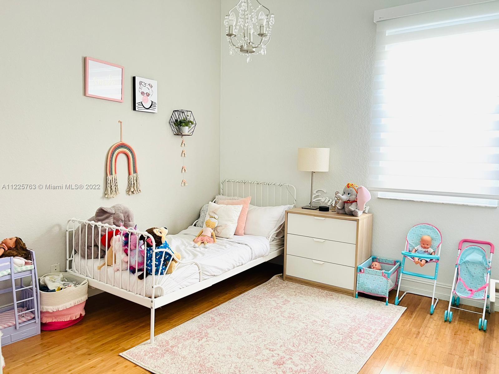 862 Tulip Circle Weston, FL 33327 - Photo 19 of 29 a bedroom with a bed and a table