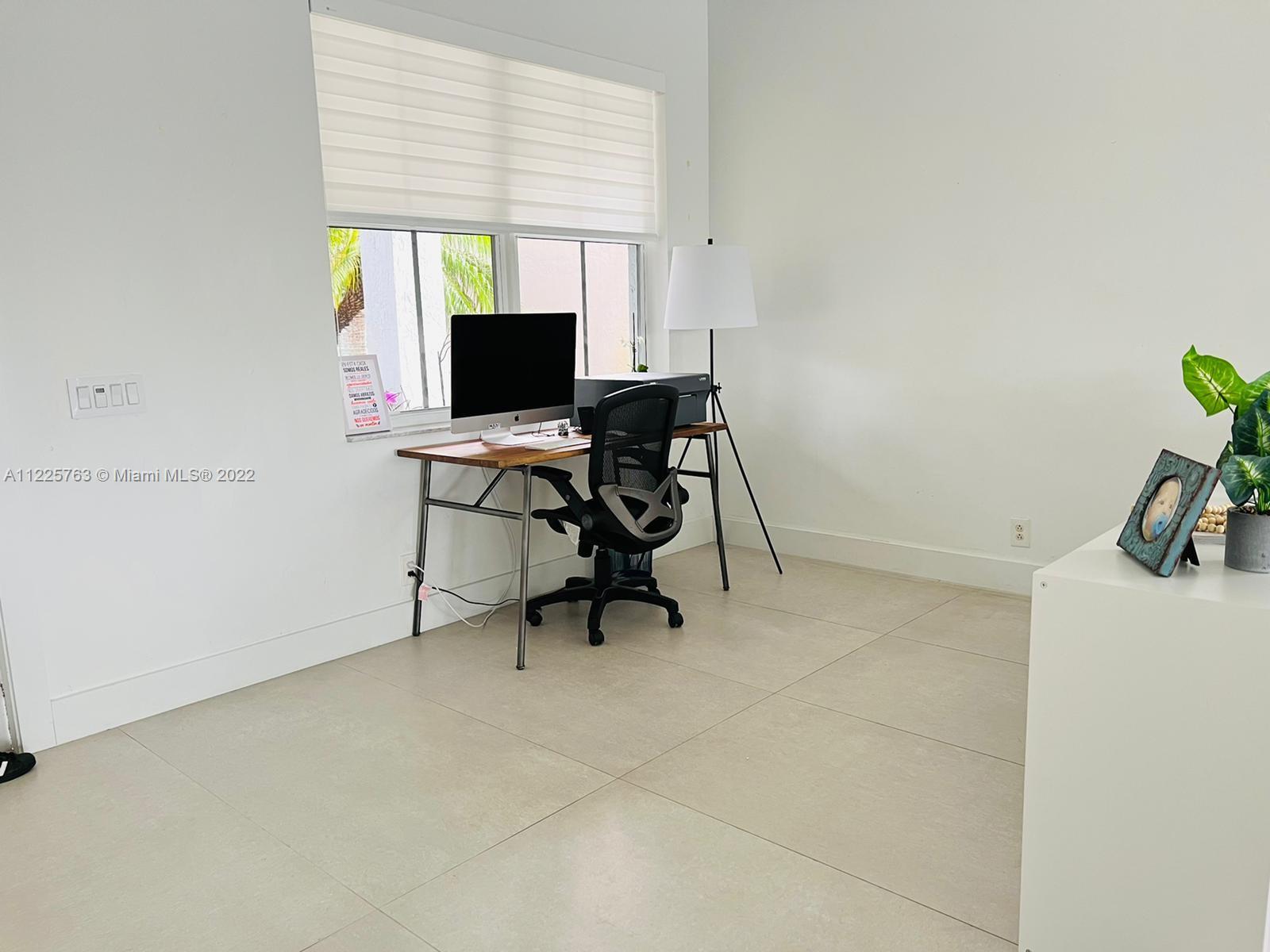 862 Tulip Circle Weston, FL 33327 - Photo 2 of 29 a view of a workspace with furniture and a window
