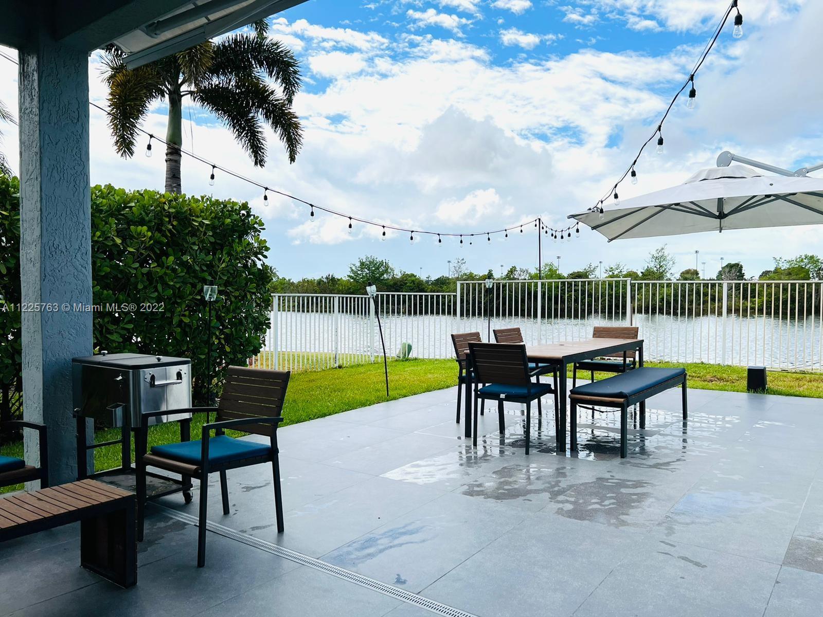 862 Tulip Circle Weston, FL 33327 - Photo 22 of 29 a view of a swimming pool with a patio and a garden