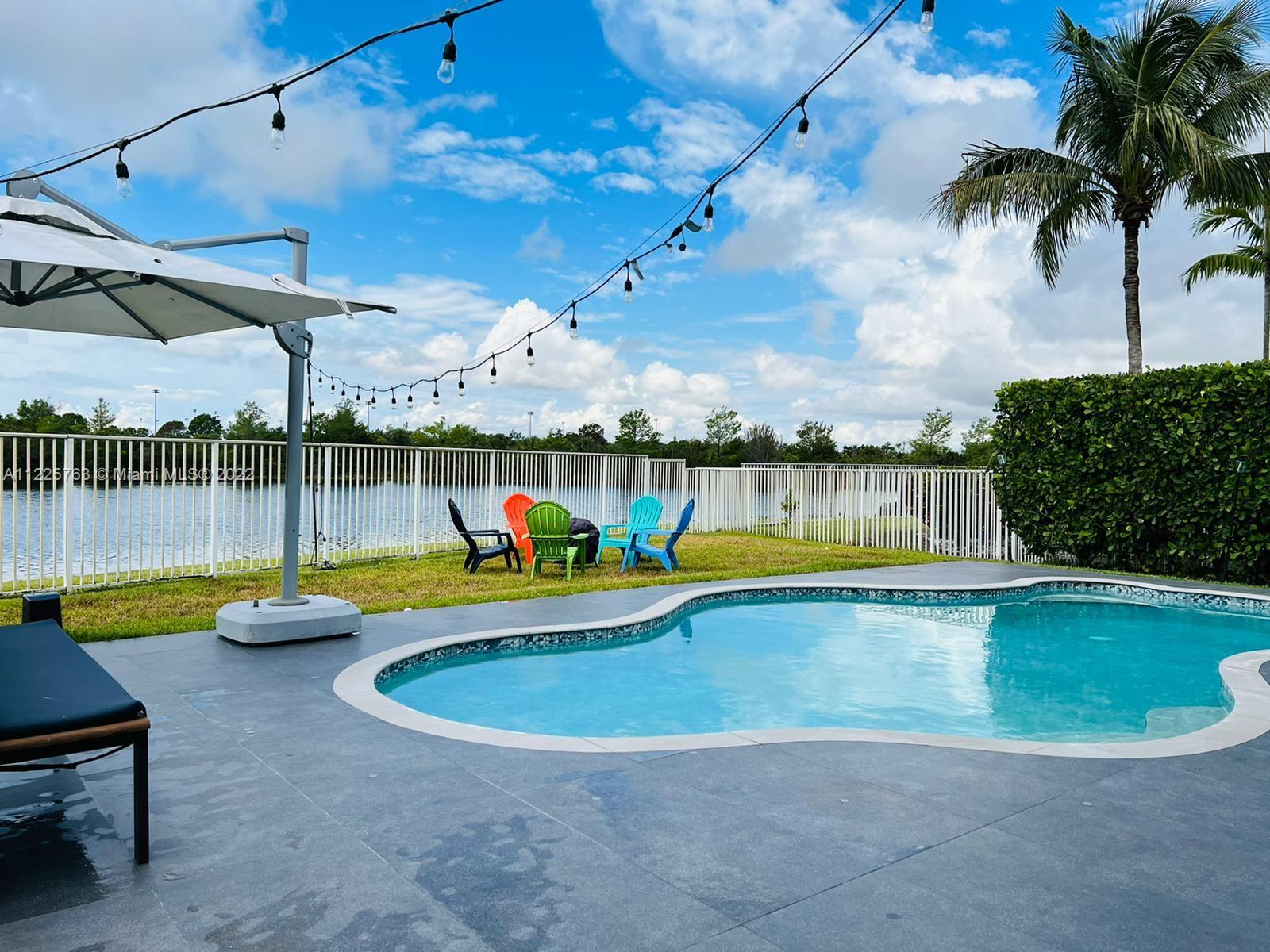 862 Tulip Circle Weston, FL 33327 - Photo 23 of 29 a view of a swimming pool with a patio
