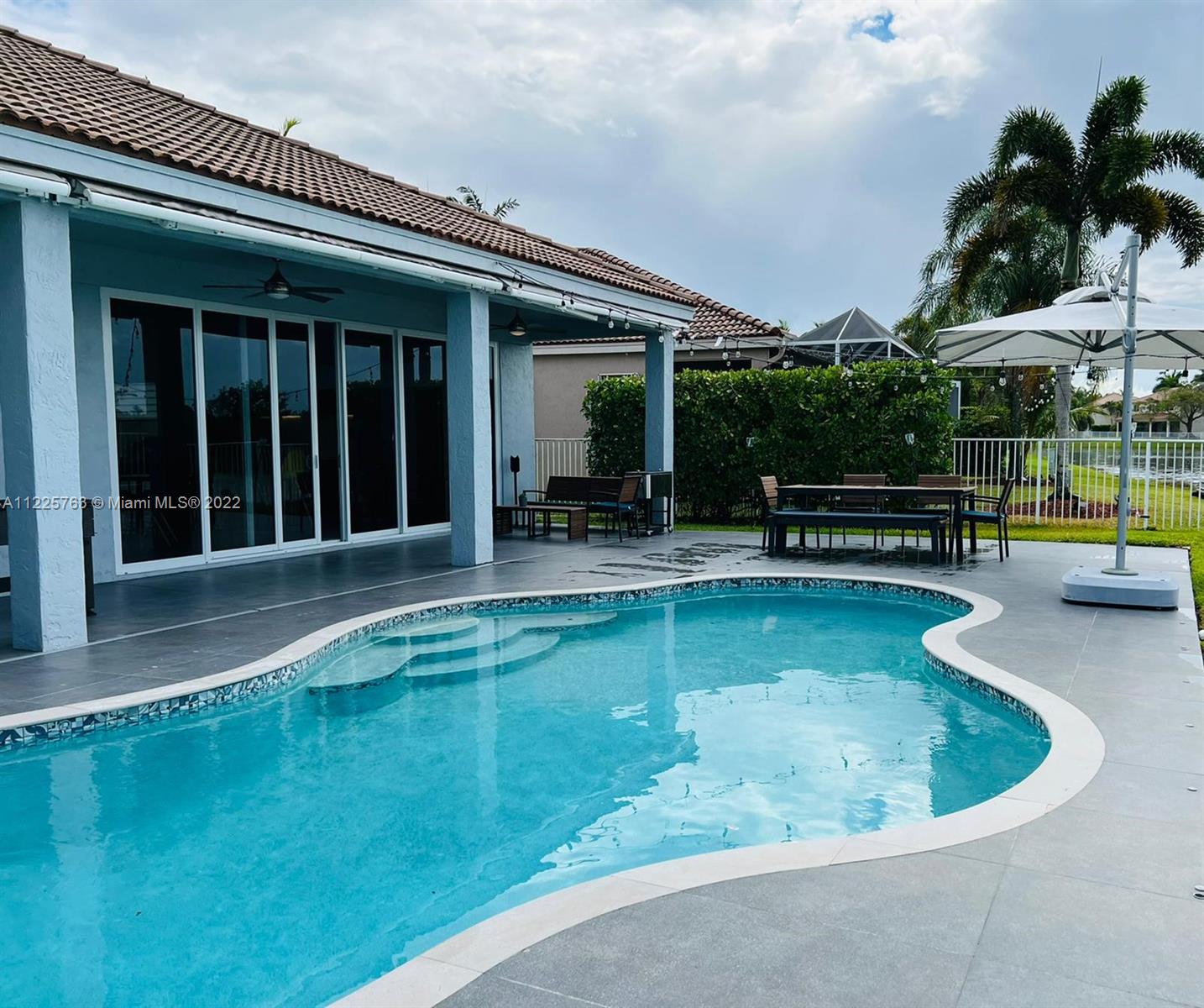 862 Tulip Circle Weston, FL 33327 - Photo 25 of 29 a swimming pool with outdoor seating and yard