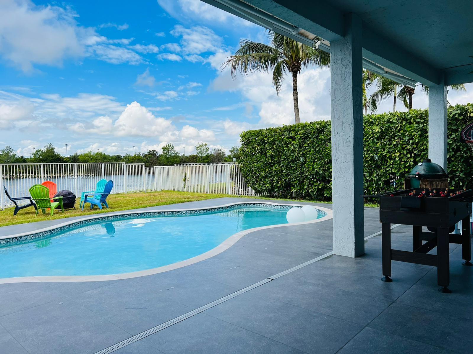 862 Tulip Circle Weston, FL 33327 - Photo 26 of 29 a view of a swimming pool with a patio