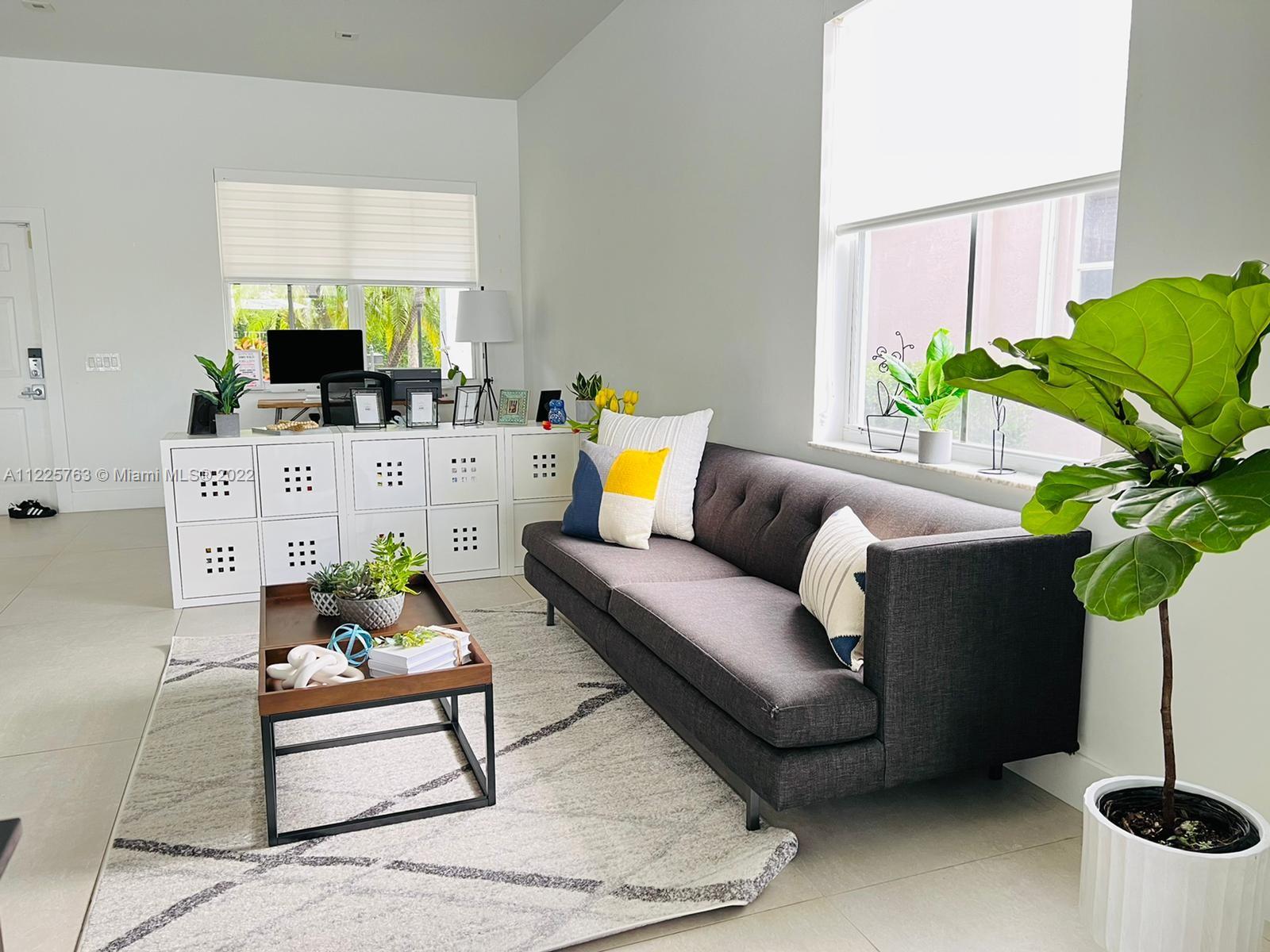 862 Tulip Circle Weston, FL 33327 - Photo 4 of 29 a living room with furniture and a potted plant