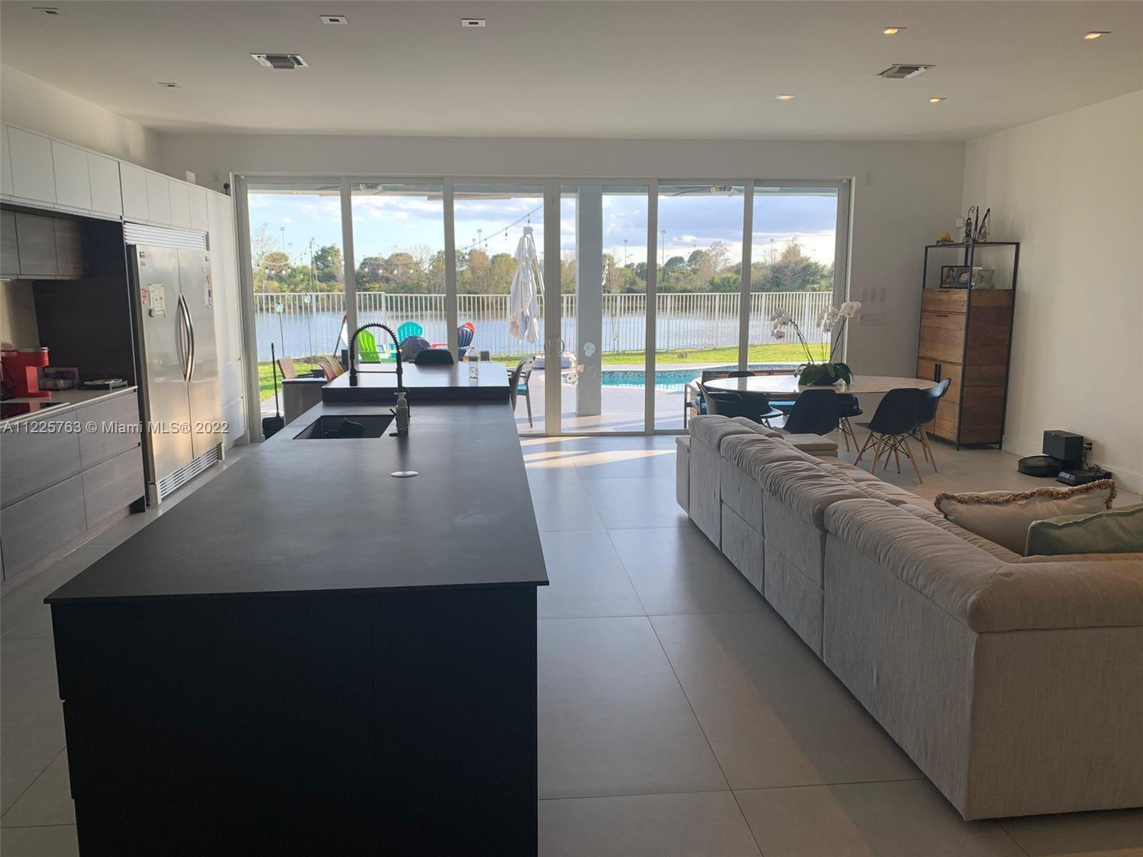 862 Tulip Circle Weston, FL 33327 - Photo 5 of 29 a living room with furniture and a flat screen tv