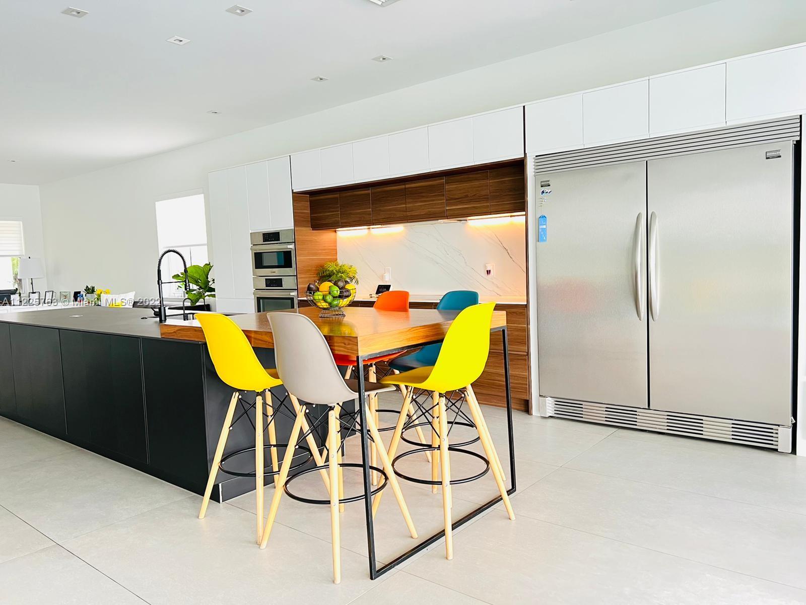 862 Tulip Circle Weston, FL 33327 - Photo 8 of 29 a dining room filled chandelier and kitchen view