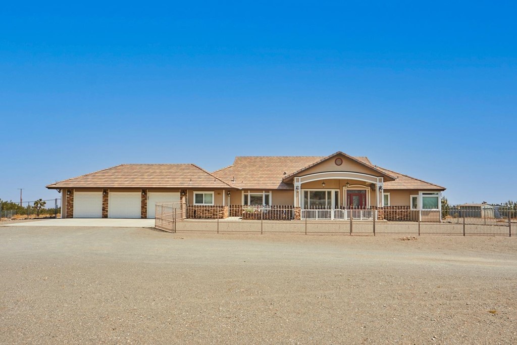 2932 Smoke Tree Road Phelan, CA 92371 - Photo 1 of 1 a front view of a house with a yard