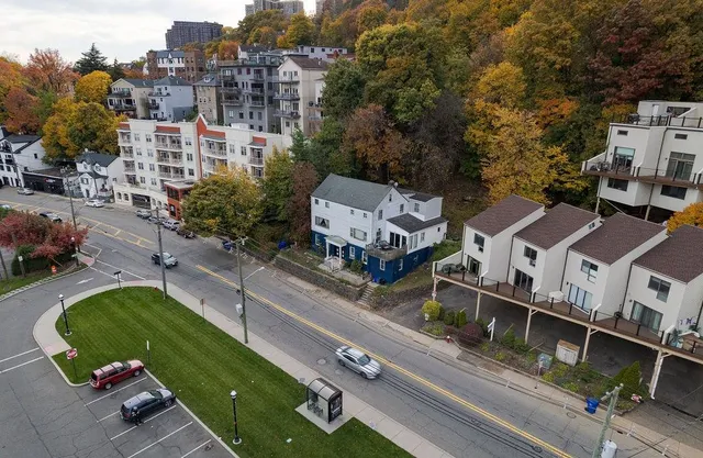 an aerial view of a house with large trees