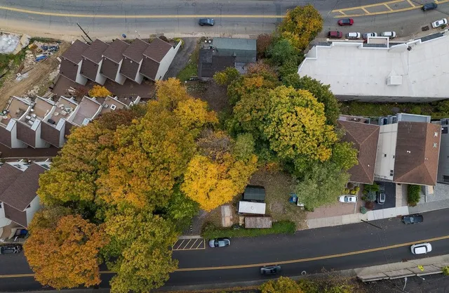 an aerial view of a house with a yard and garden