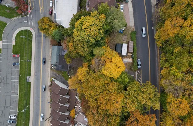 an aerial view of a house with a yard basket ball court and outdoor seating