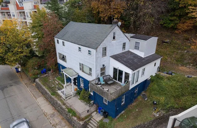 an aerial view of a house with a yard