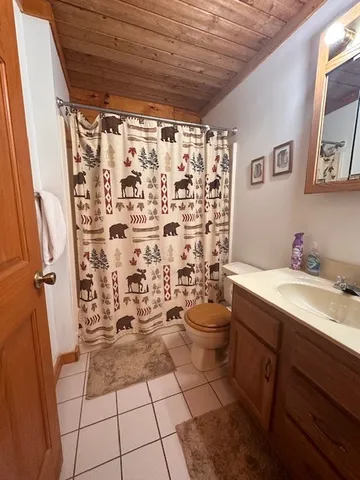 a bedroom with a bed and a mirror