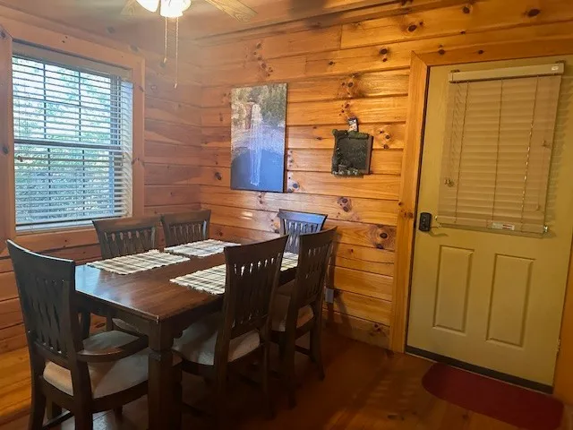 a living room with furniture fireplace and a large window