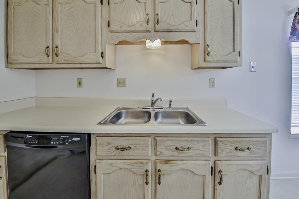 7448 Gingerhill Lane Bartlett, TN 38133 - Photo 11 of 39 a kitchen with white cabinets and a sink