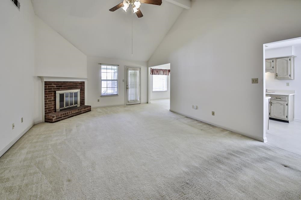 7448 Gingerhill Lane Bartlett, TN 38133 - Photo 14 of 39 an empty room with windows and fireplace