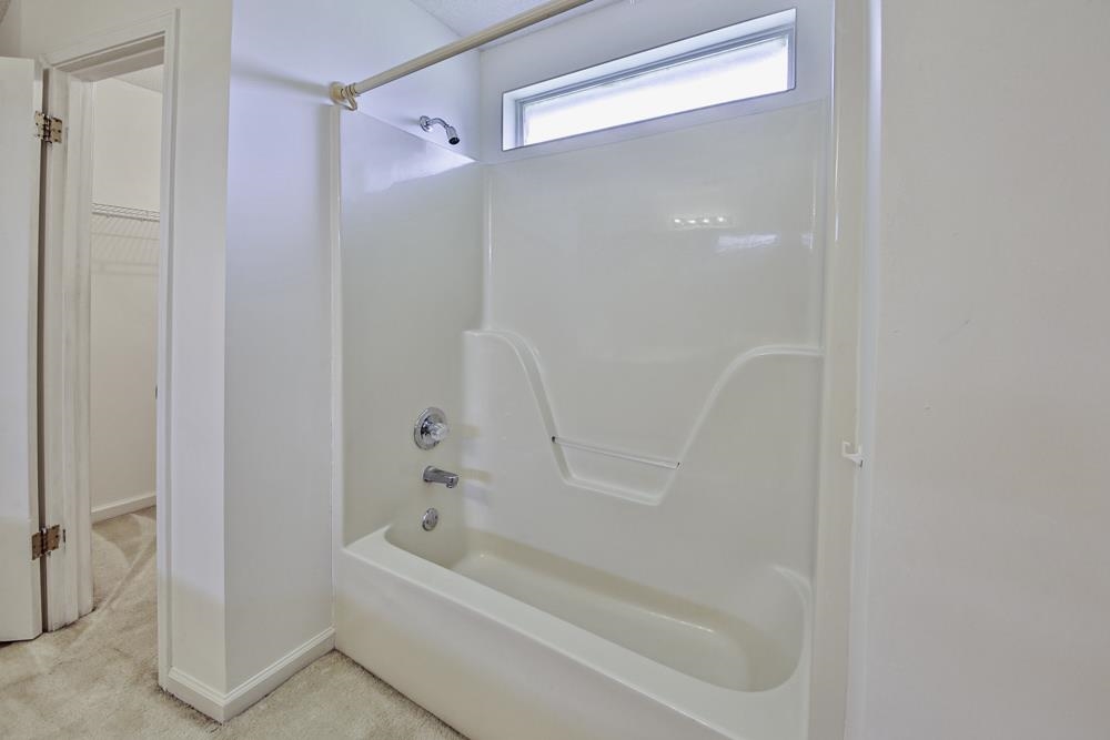 7448 Gingerhill Lane Bartlett, TN 38133 - Photo 23 of 39 a bathroom with a bathtub and a shower