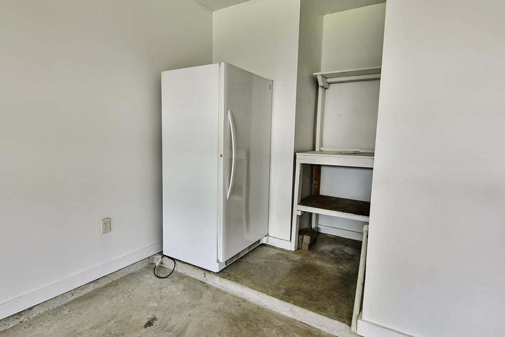 7448 Gingerhill Lane Bartlett, TN 38133 - Photo 29 of 39 a view of a kitchen with a refrigerator and more cabinets