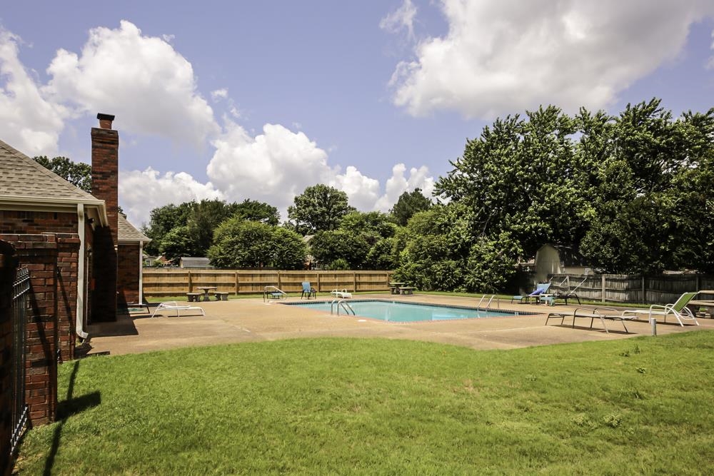 7448 Gingerhill Lane Bartlett, TN 38133 - Photo 38 of 39 a view of a swimming pool with an outdoor seating and a yard