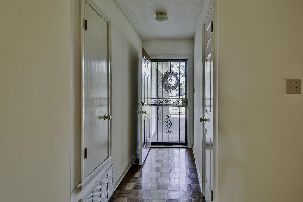 7448 Gingerhill Lane Bartlett, TN 38133 - Photo 6 of 39 a view of a hallway with wooden floor and a bathroom