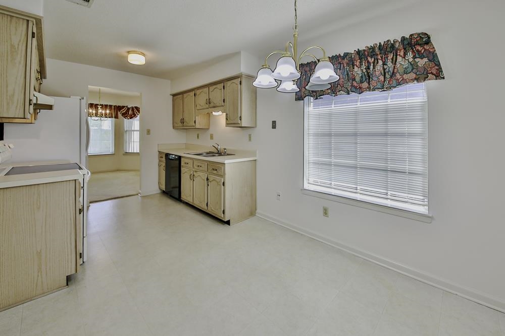 7448 Gingerhill Lane Bartlett, TN 38133 - Photo 9 of 39 a kitchen with cabinets a sink and appliances