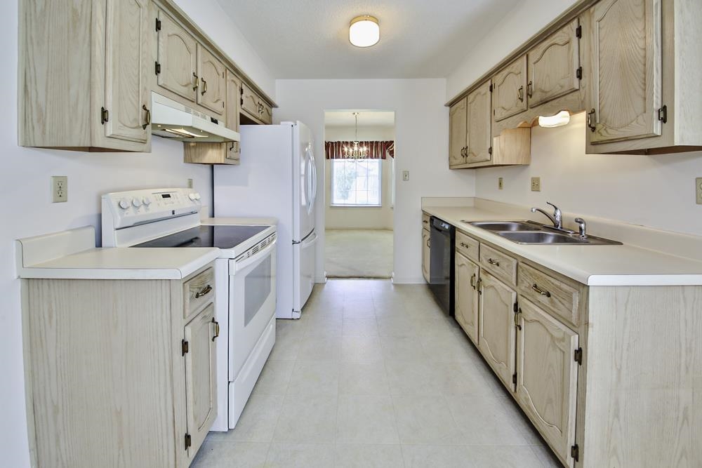 7448 Gingerhill Lane Bartlett, TN 38133 - Photo 10 of 39 a kitchen with stainless steel appliances granite countertop a sink and a stove