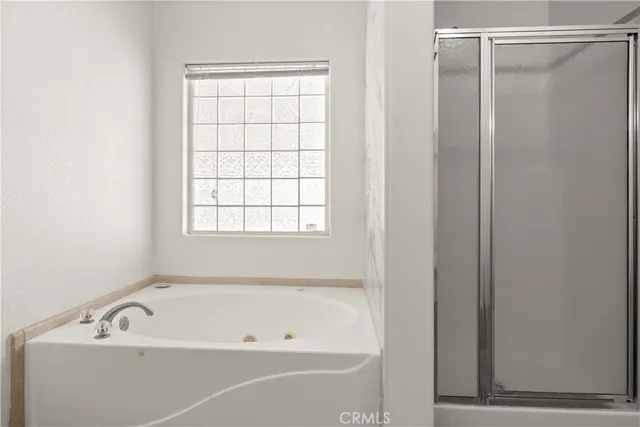 a bathroom with a tub and a shower